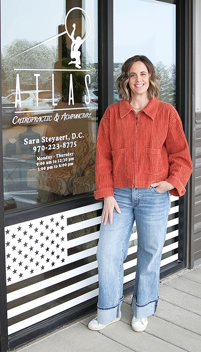 Dr. Sara Steyaert standing outside the Atlas Chiropractic & Acupuncture office in Windsor, CO
